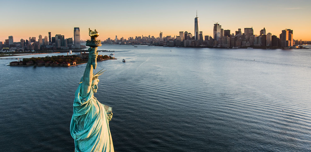 Lady Liberty and the city at dawn