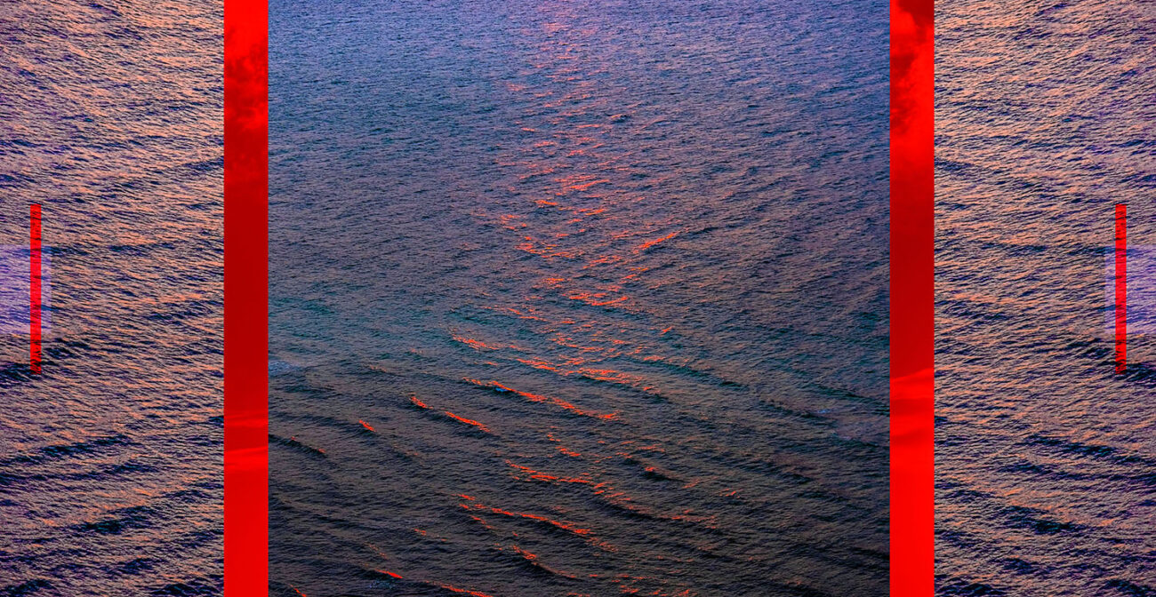 Ocean with red light at sunup